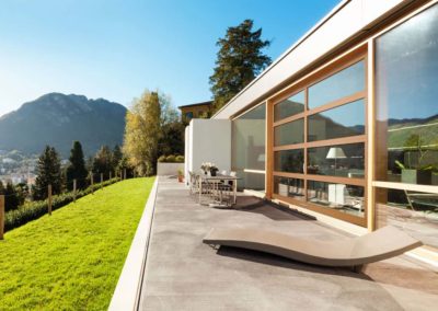 Contemporary home featuring a large glass garage door, seamlessly blending indoor and outdoor living space