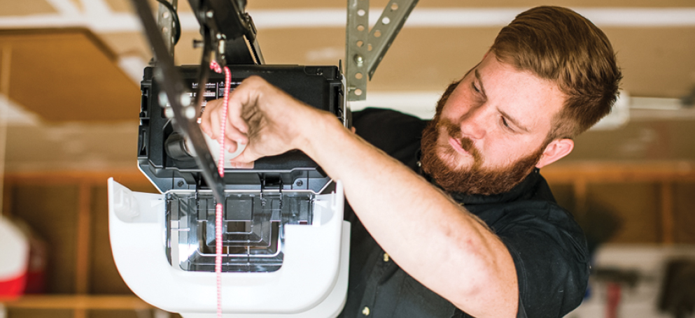 Precision Tech Working on a Garage Door Opener Precision Tech Working on a Garage Door Opener