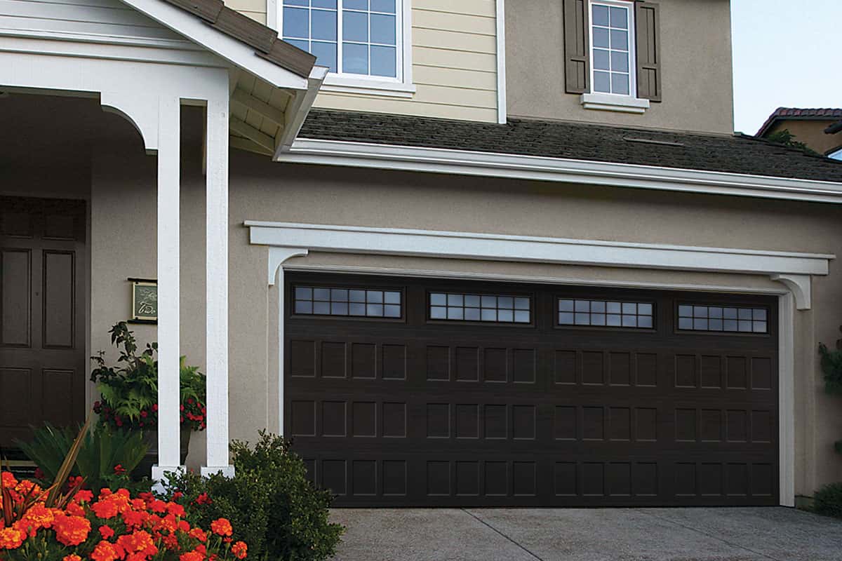 garage-door-with-recessed-panels-2 Tan house with a brown garage door that has recessed panels